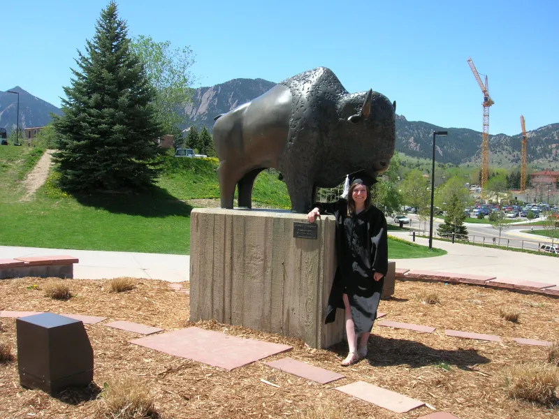 Emily Backes in cap and gown at her University of Colorado Boulder graduation